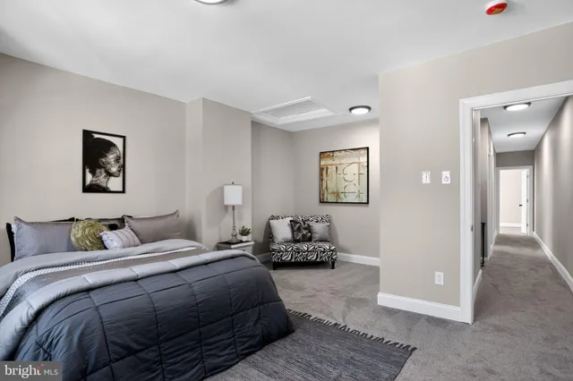 a bedroom with a bed and painting on the wall