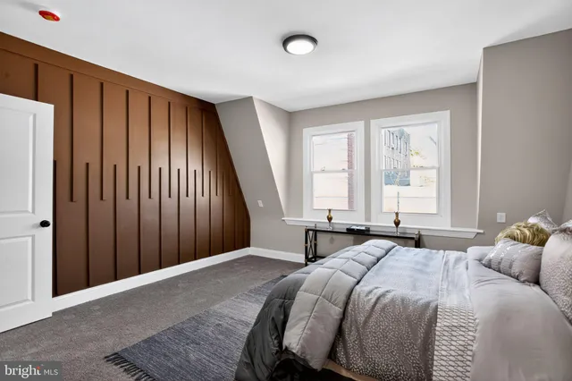 a bedroom with a large bed and a window