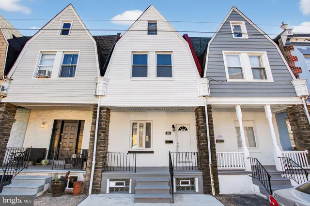 a view of a brick house with large windows