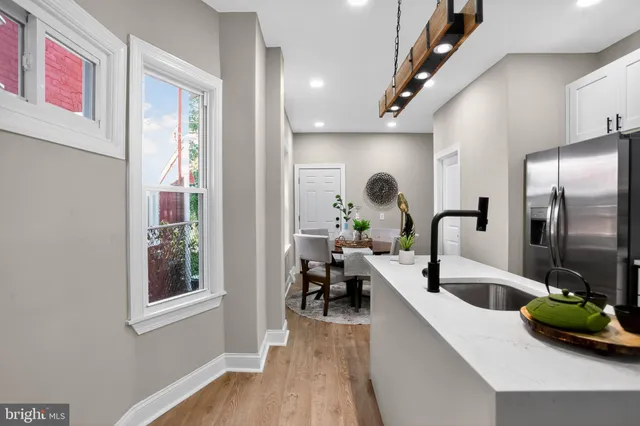 a kitchen with a refrigerator and a sink