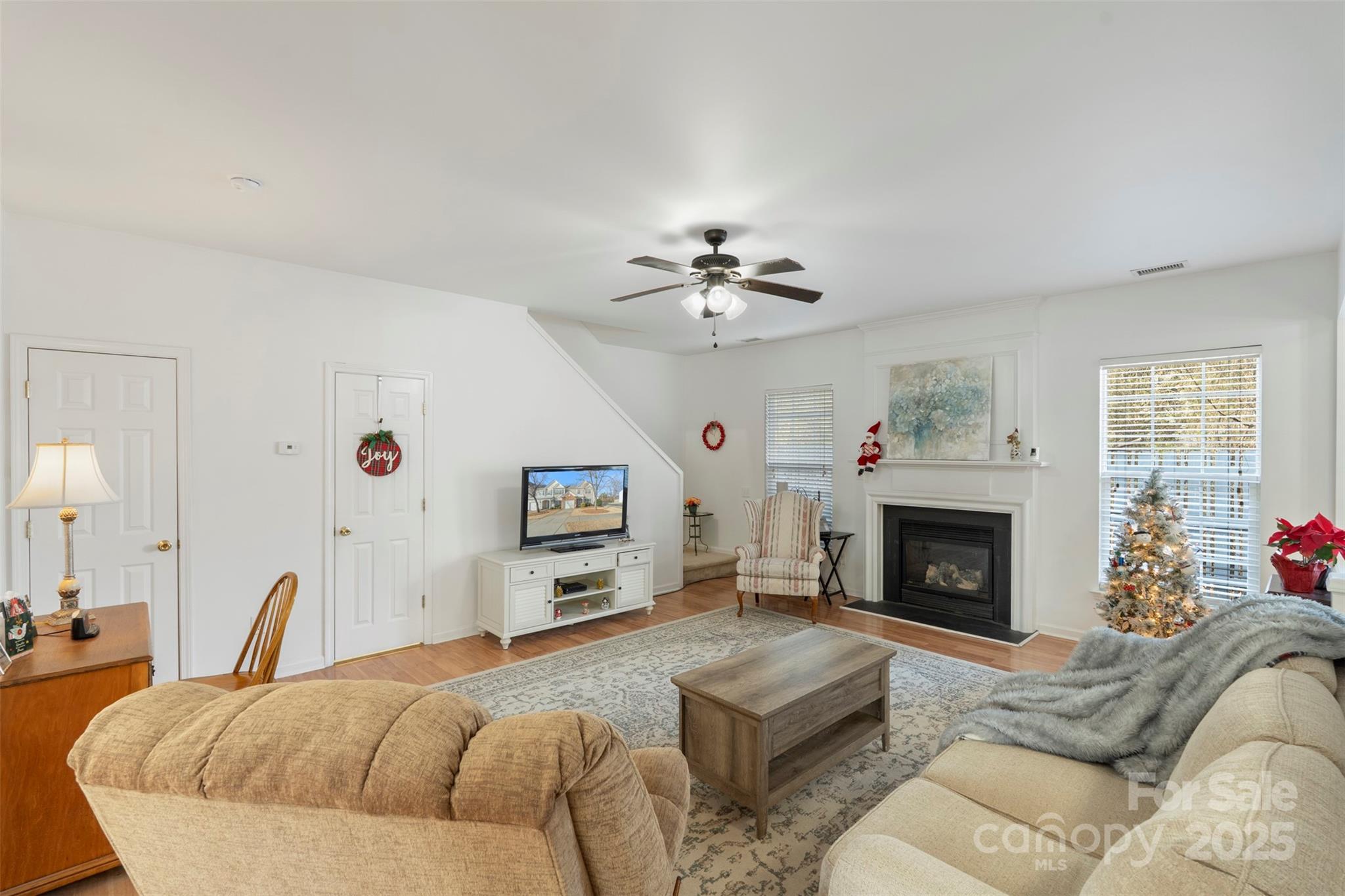 11730 Huxley Road Charlotte, NC 28277 - Photo 11 of 37 a spacious bedroom with a large bed a fireplace and a chandelier
