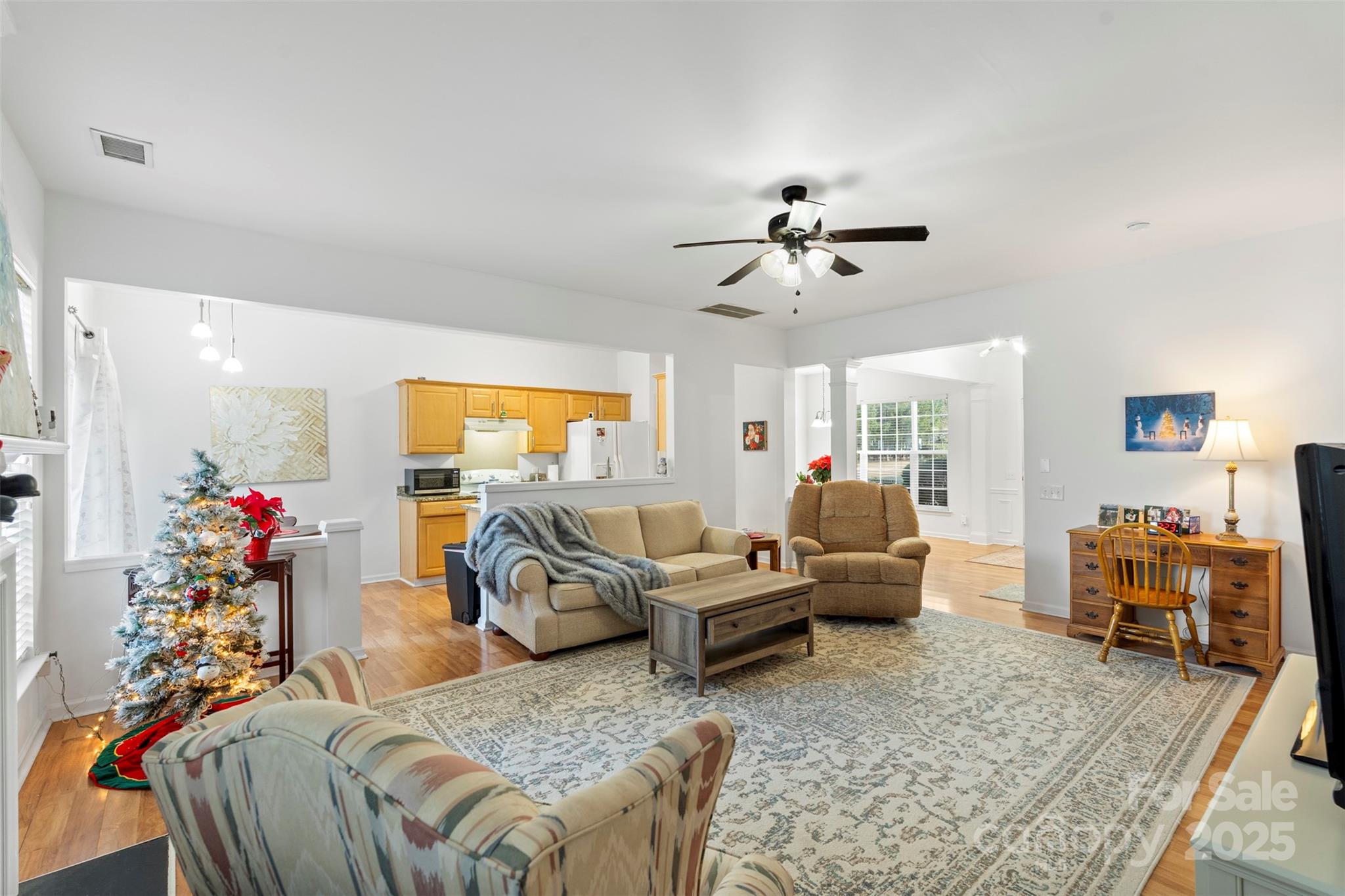 11730 Huxley Road Charlotte, NC 28277 - Photo 12 of 37 a living room with furniture ceiling fan and a rug