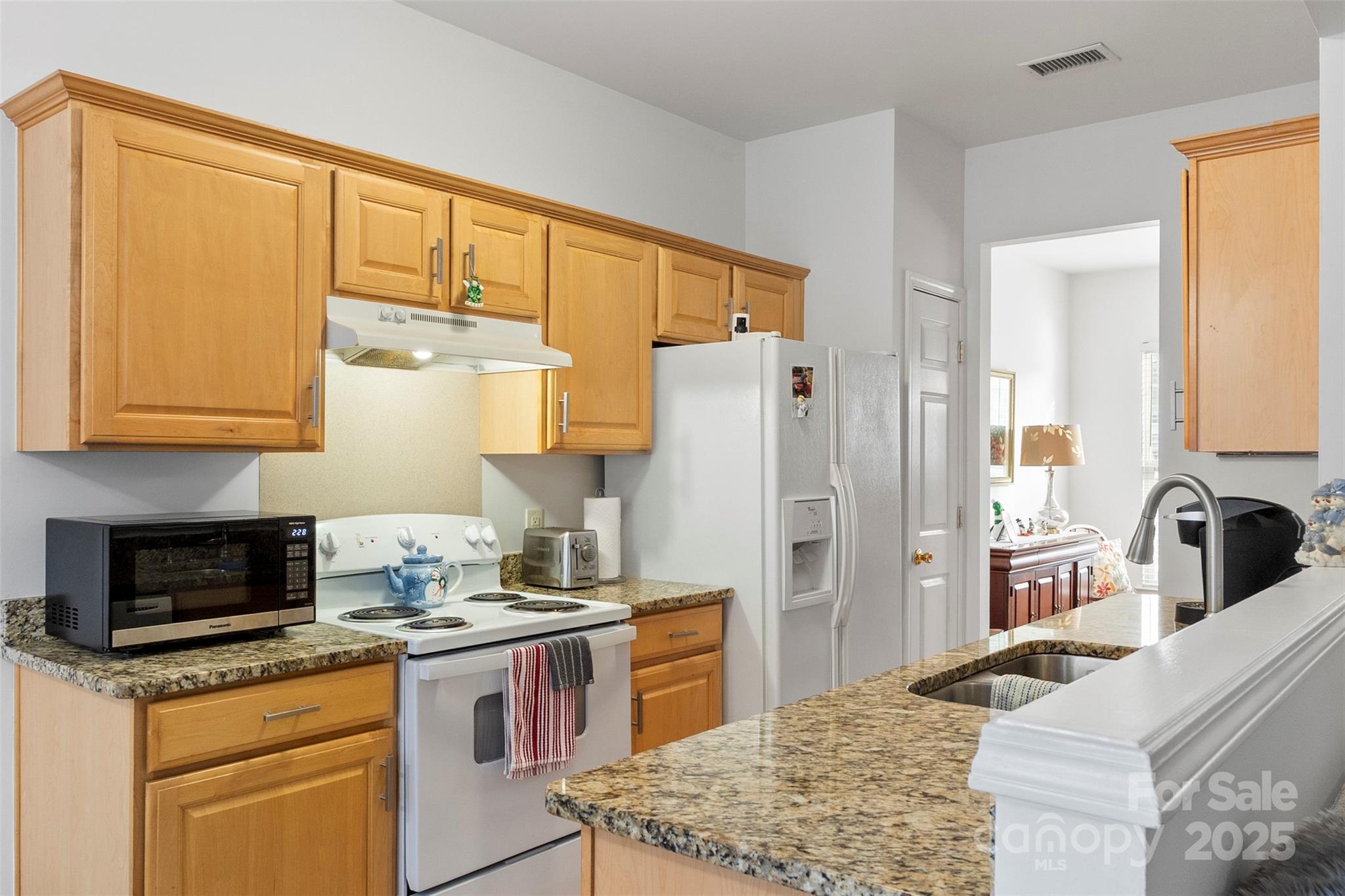 11730 Huxley Road Charlotte, NC 28277 - Photo 14 of 37 a kitchen with stainless steel appliances granite countertop a stove refrigerator sink and cabinets