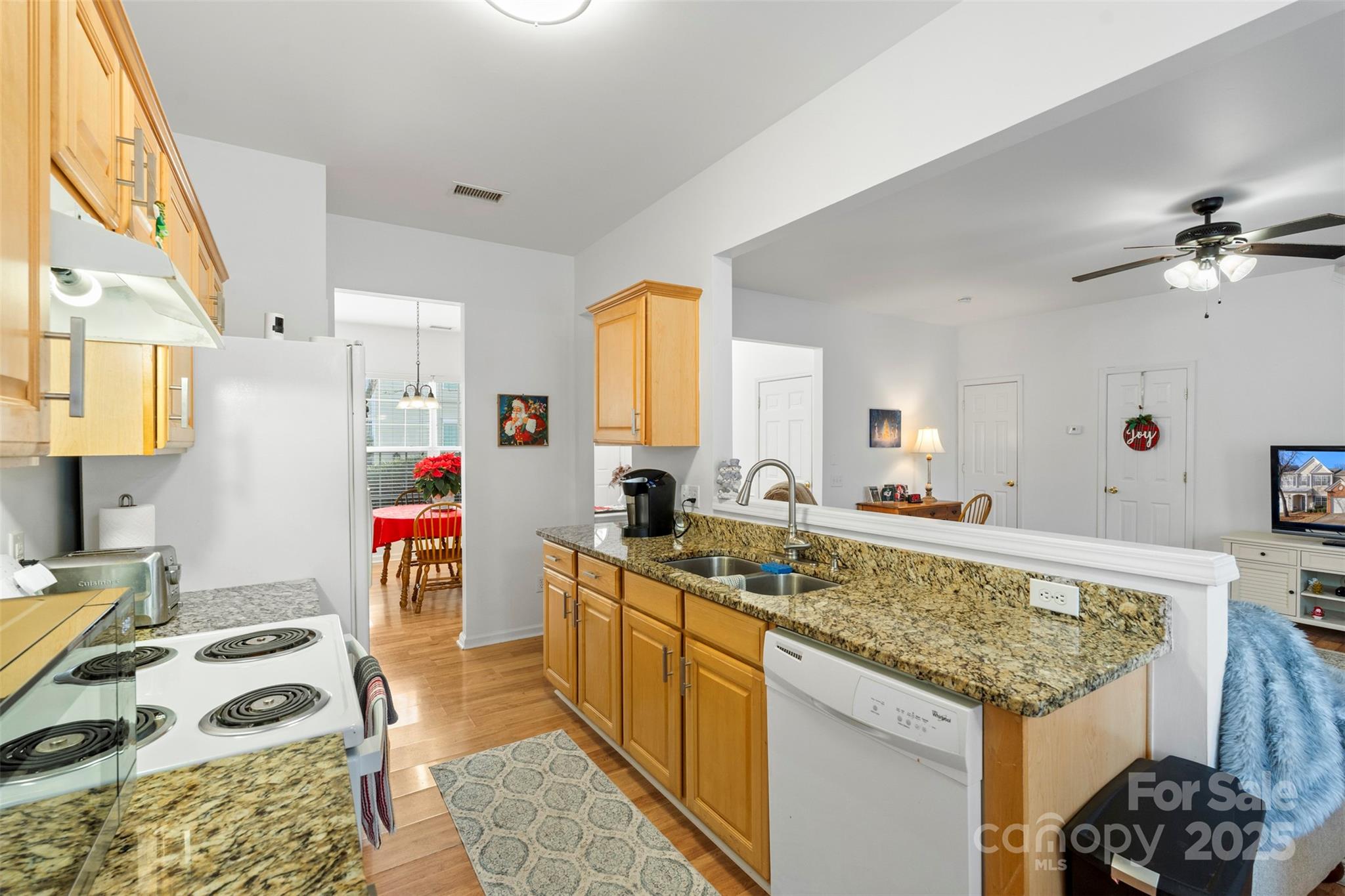 11730 Huxley Road Charlotte, NC 28277 - Photo 17 of 37 a kitchen with a stove a sink and a refrigerator
