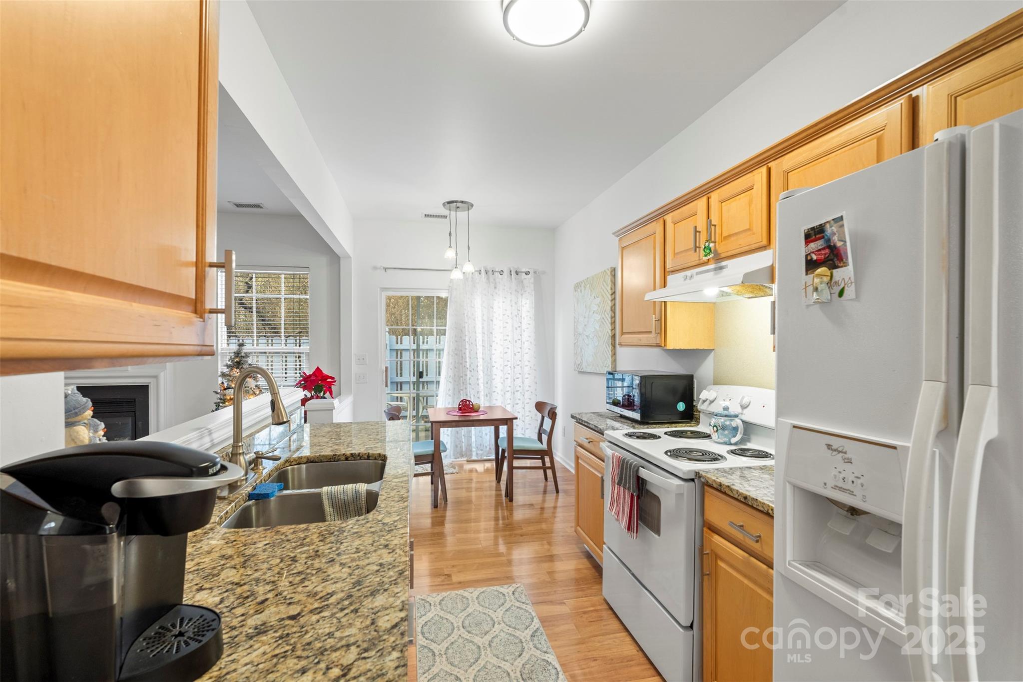 11730 Huxley Road Charlotte, NC 28277 - Photo 18 of 37 a kitchen with stainless steel appliances kitchen island granite countertop a stove a refrigerator and a dining table