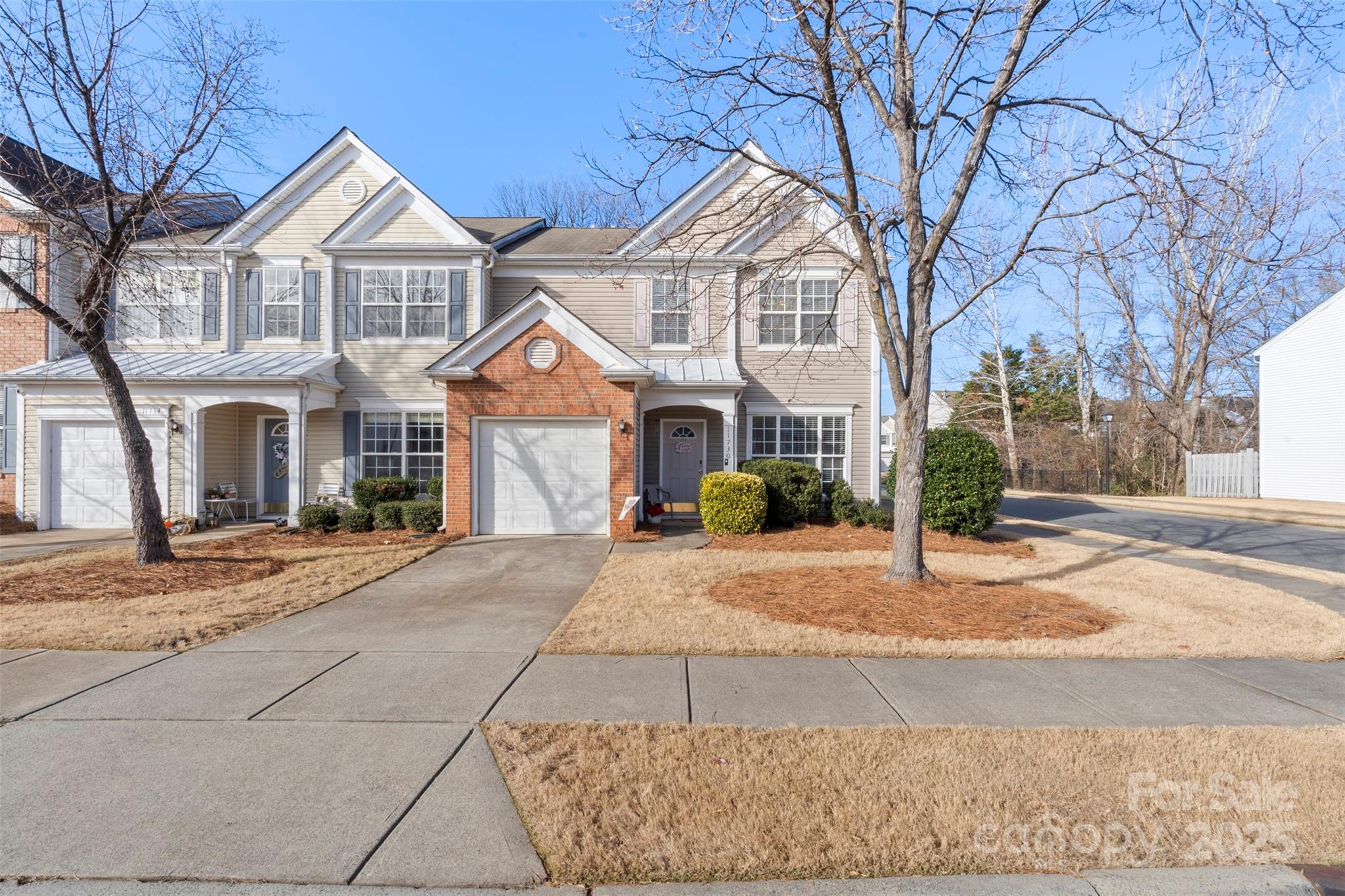 11730 Huxley Road Charlotte, NC 28277 - Photo 2 of 37 a front view of a house with a yard and garage