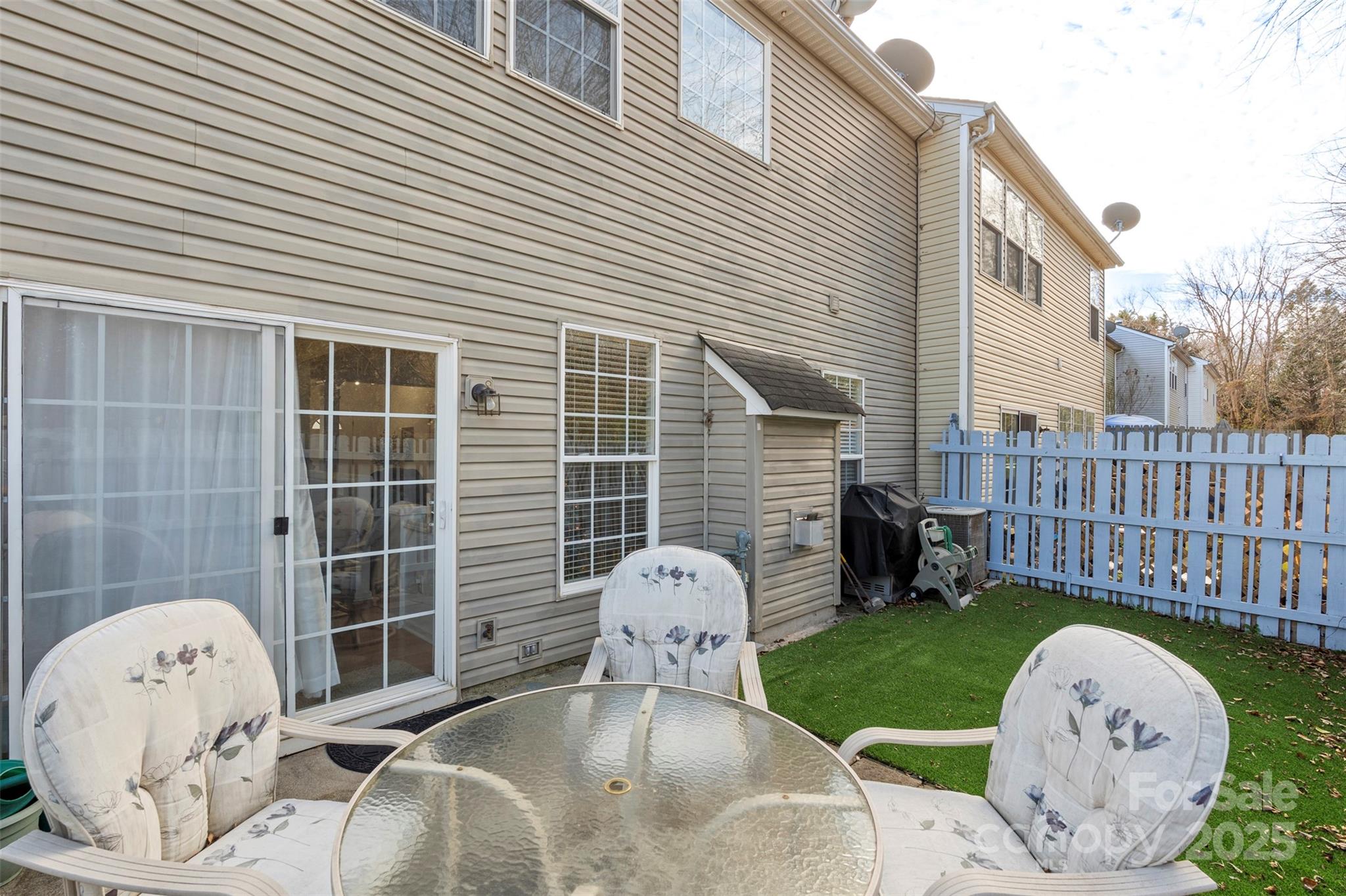 11730 Huxley Road Charlotte, NC 28277 - Photo 22 of 37 a view of a chair and table in backyard of the house