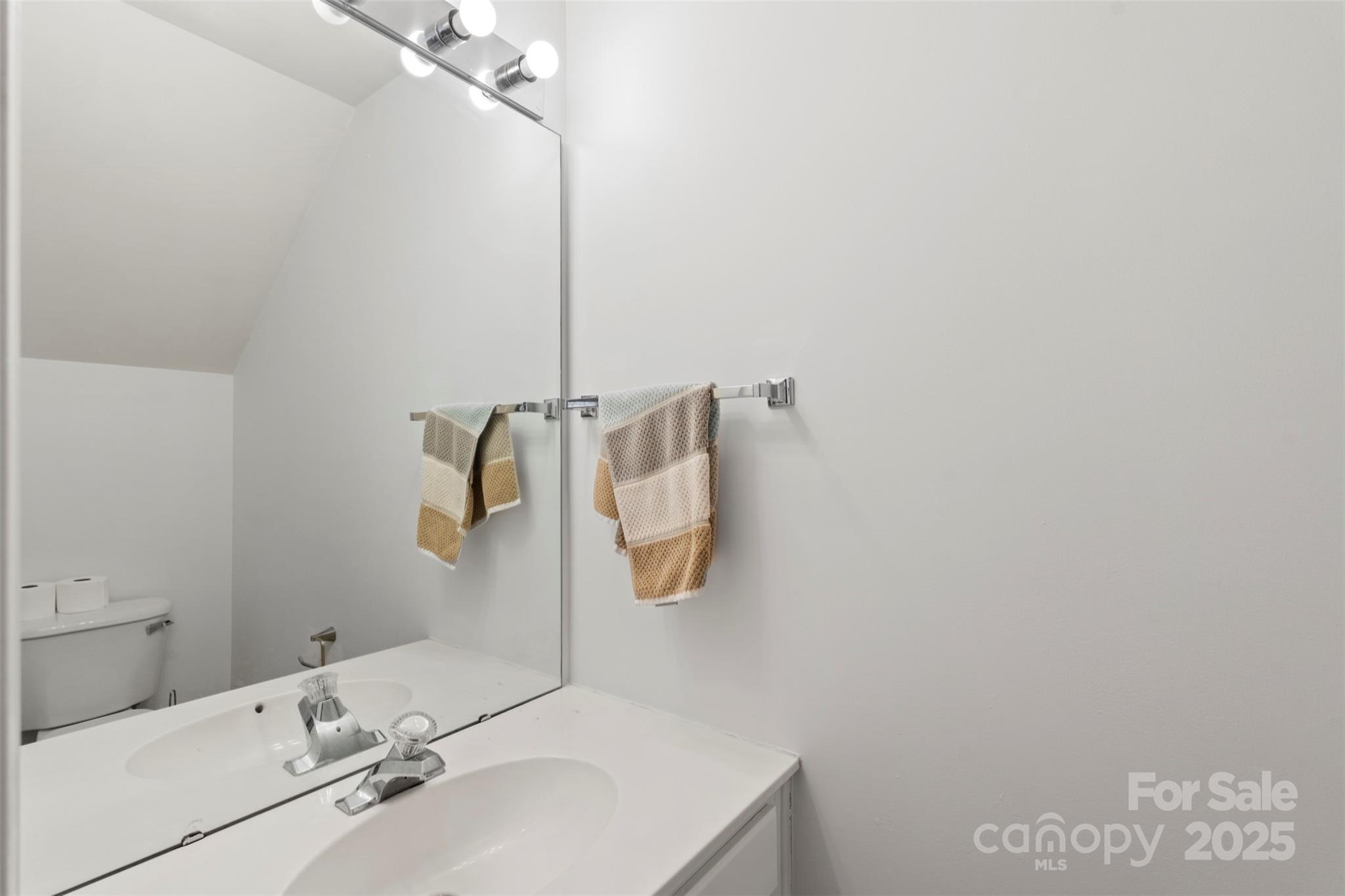 11730 Huxley Road Charlotte, NC 28277 - Photo 24 of 37 a bathroom with a sink and a mirror