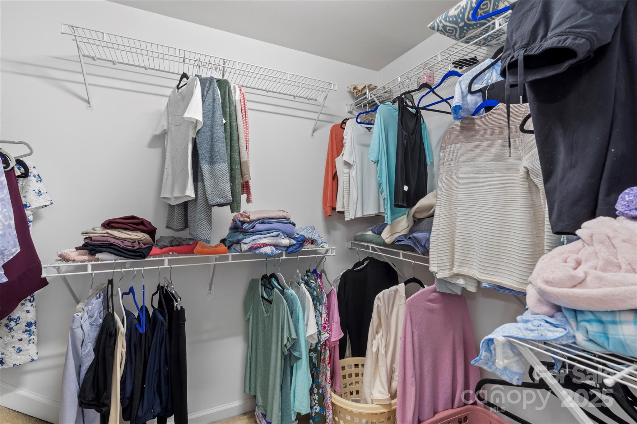 11730 Huxley Road Charlotte, NC 28277 - Photo 31 of 37 a view of walk in closet with clothes and shoes