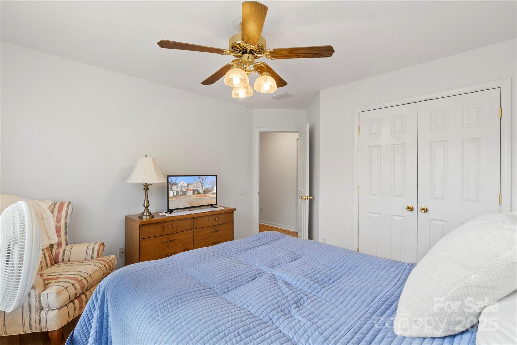 11730 Huxley Road Charlotte, NC 28277 - Photo 33 of 37 a bedroom with a bed and a chandelier