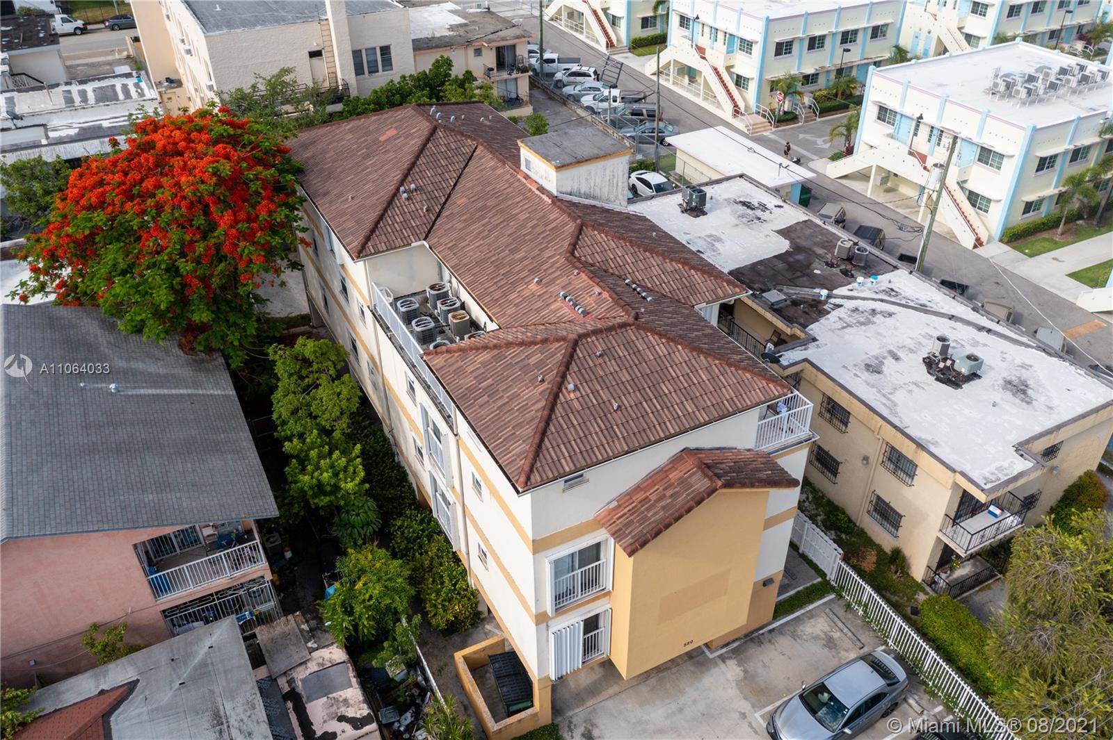 an aerial view of multiple houses with yard