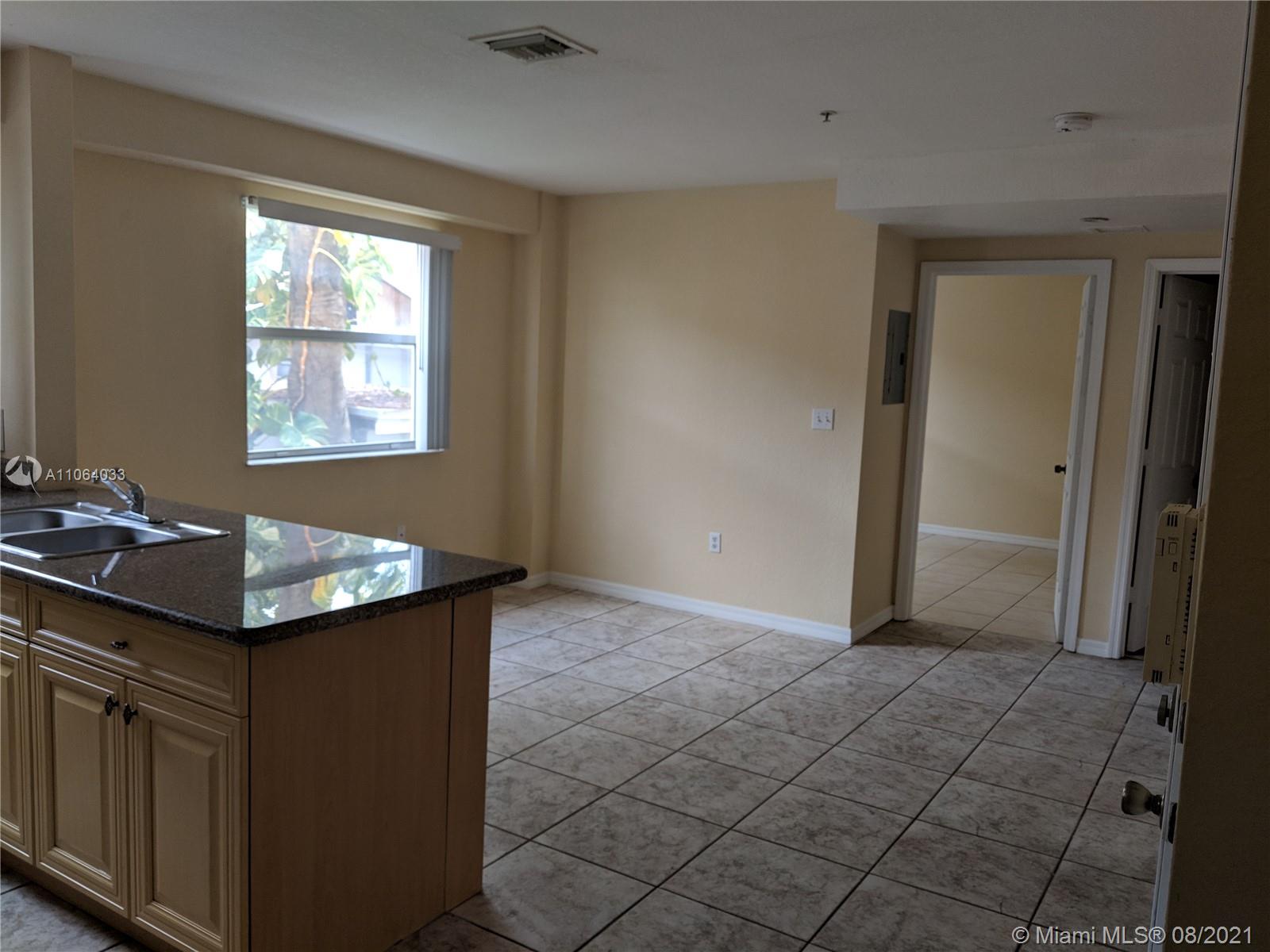 520 Southwest 5th Street, Unit 303 Miami, FL 33130 - Photo 4 of 49 a bathroom with a sink a vanity and a mirror