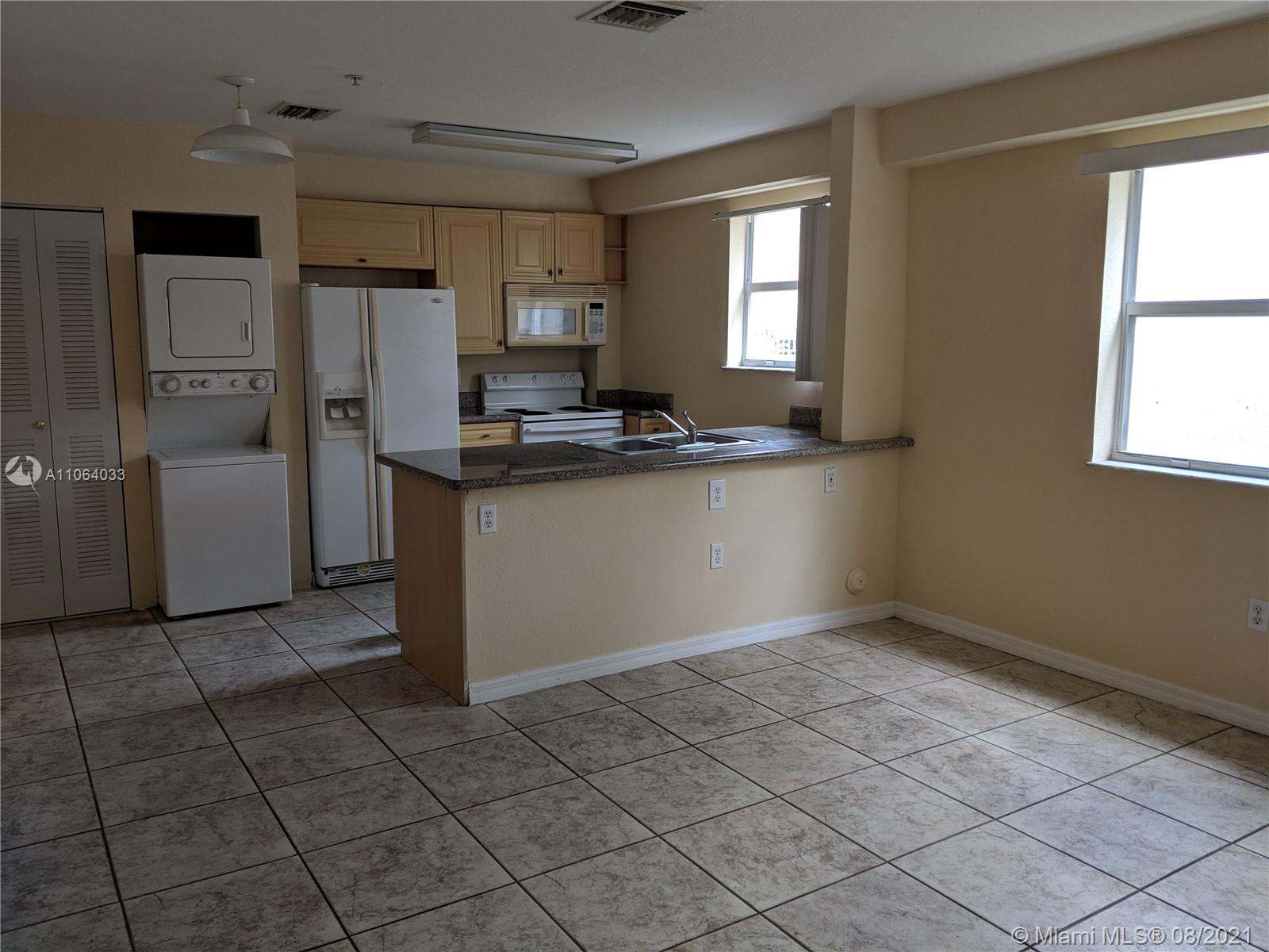 520 Southwest 5th Street, Unit 303 Miami, FL 33130 - Photo 6 of 49 a kitchen with stainless steel appliances granite countertop a refrigerator and a sink