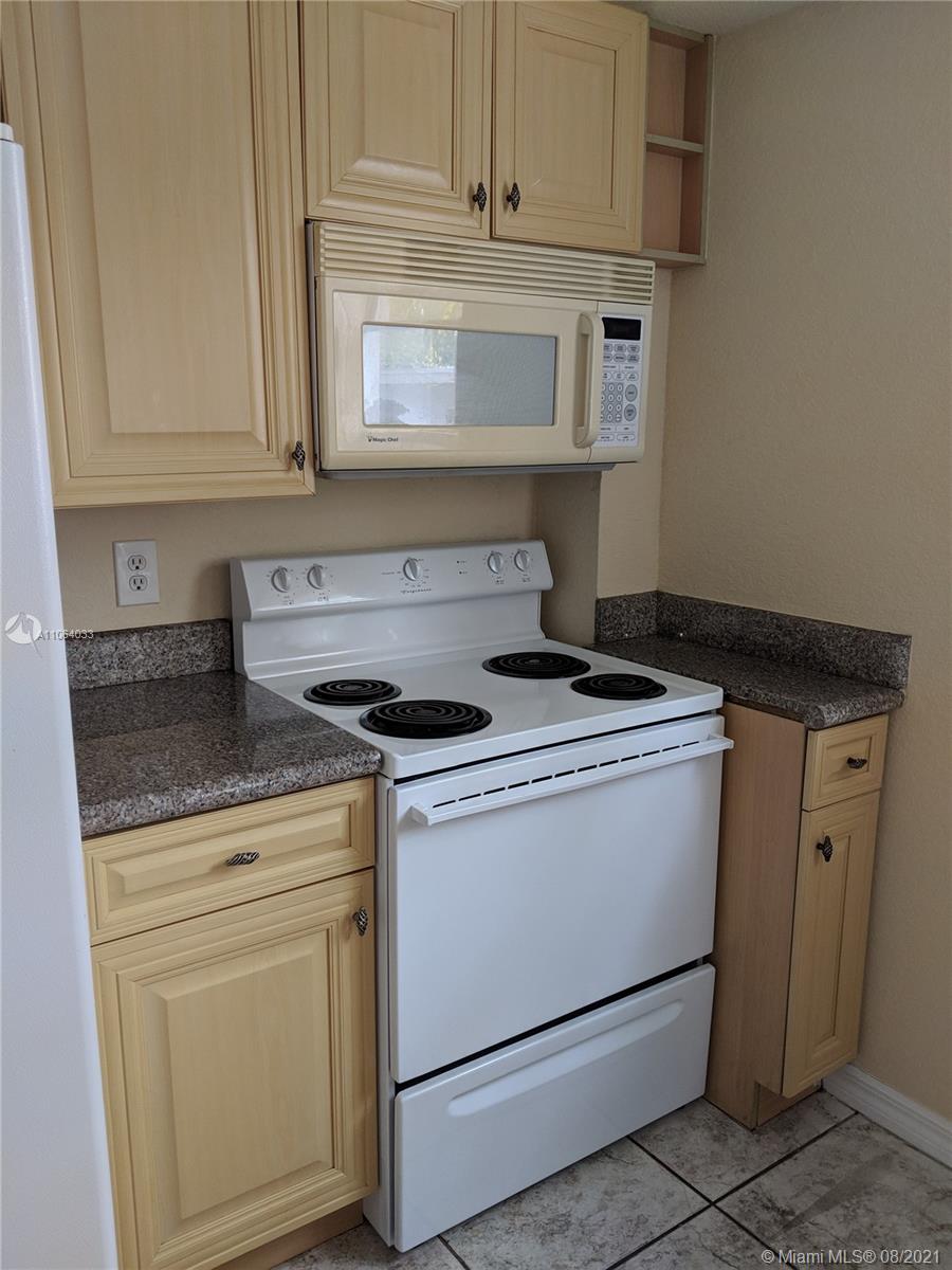 520 Southwest 5th Street, Unit 303 Miami, FL 33130 - Photo 7 of 49 a stove top oven sitting inside of a kitchen