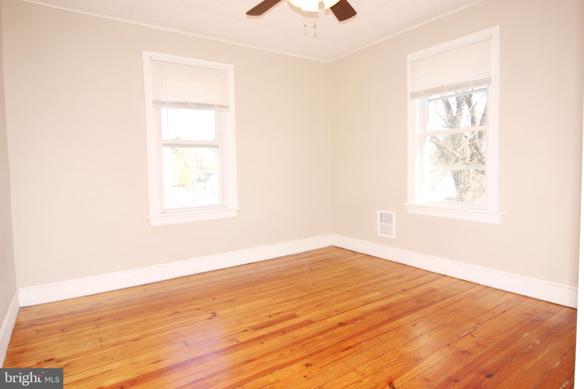 312 West Monroe Avenue Magnolia, NJ 08049 - Photo 13 of 29 an empty room with wooden floor and windows