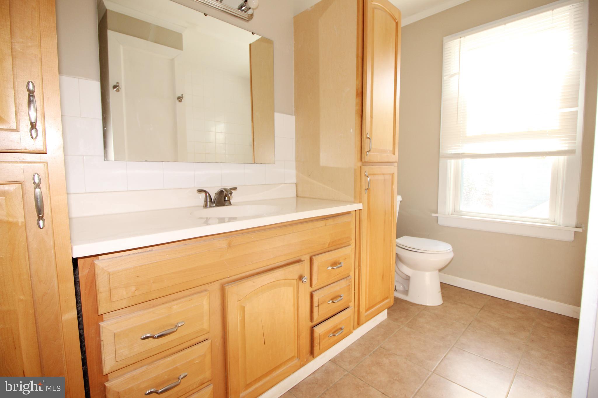 312 West Monroe Avenue Magnolia, NJ 08049 - Photo 15 of 29 a bathroom with a sink a toilet and a mirror