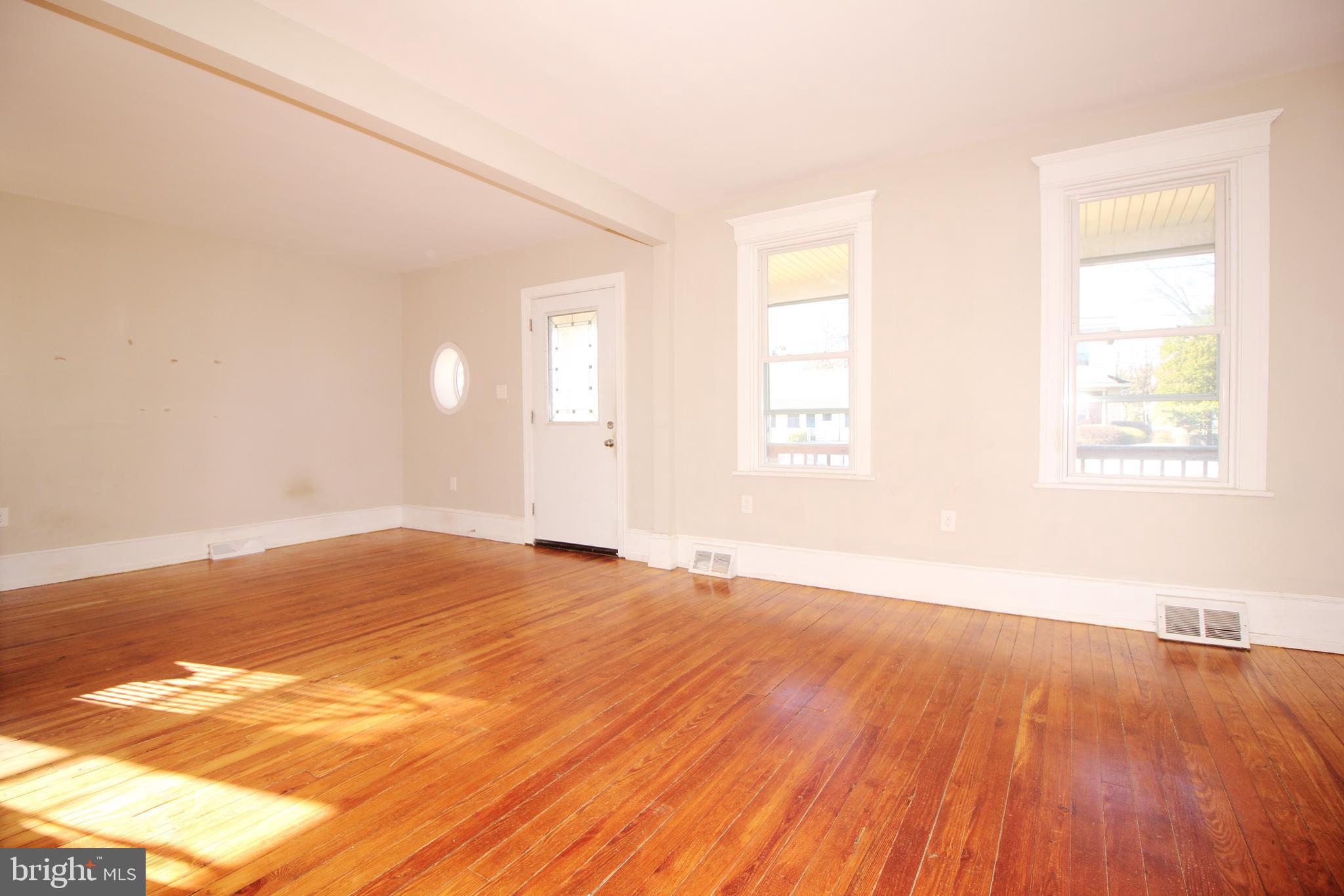 312 West Monroe Avenue Magnolia, NJ 08049 - Photo 5 of 29 an empty room with wooden floor and windows