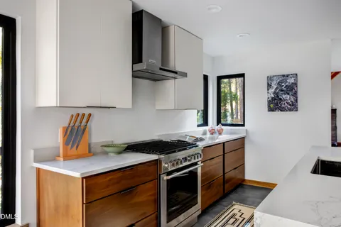 a kitchen with stainless steel appliances a stove a sink and a refrigerator