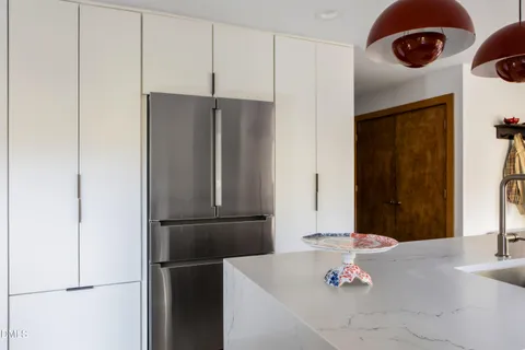 a kitchen with a refrigerator and a window