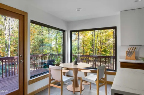 a dining room with furniture window and outside view