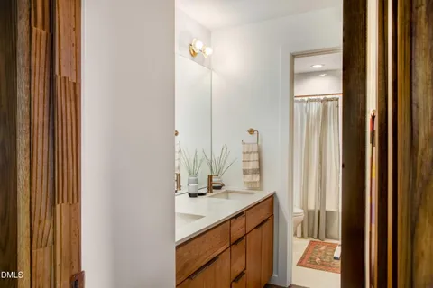 a bathroom with a sink vanity and a mirror