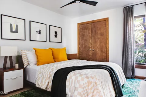 a bedroom with a large bed and a window