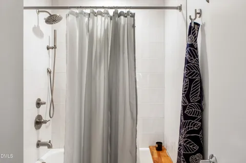 a view of a bathroom with a shower curtain