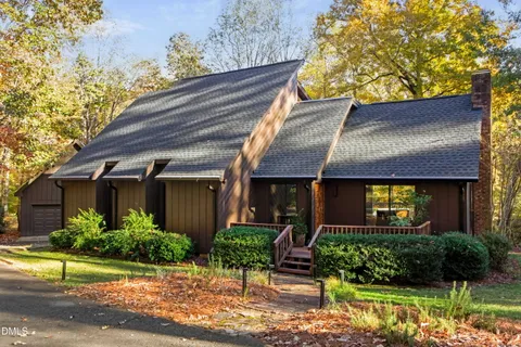 a front view of house with a garden