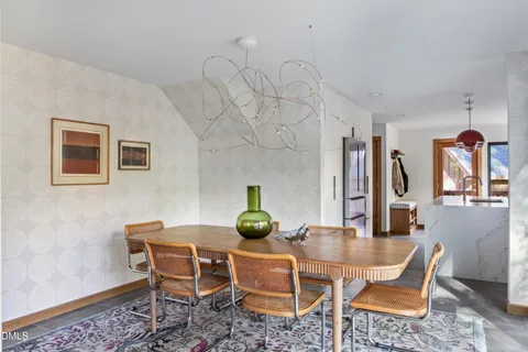 a dining room with furniture and window