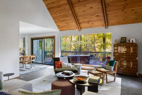a living room with furniture and a floor to ceiling window
