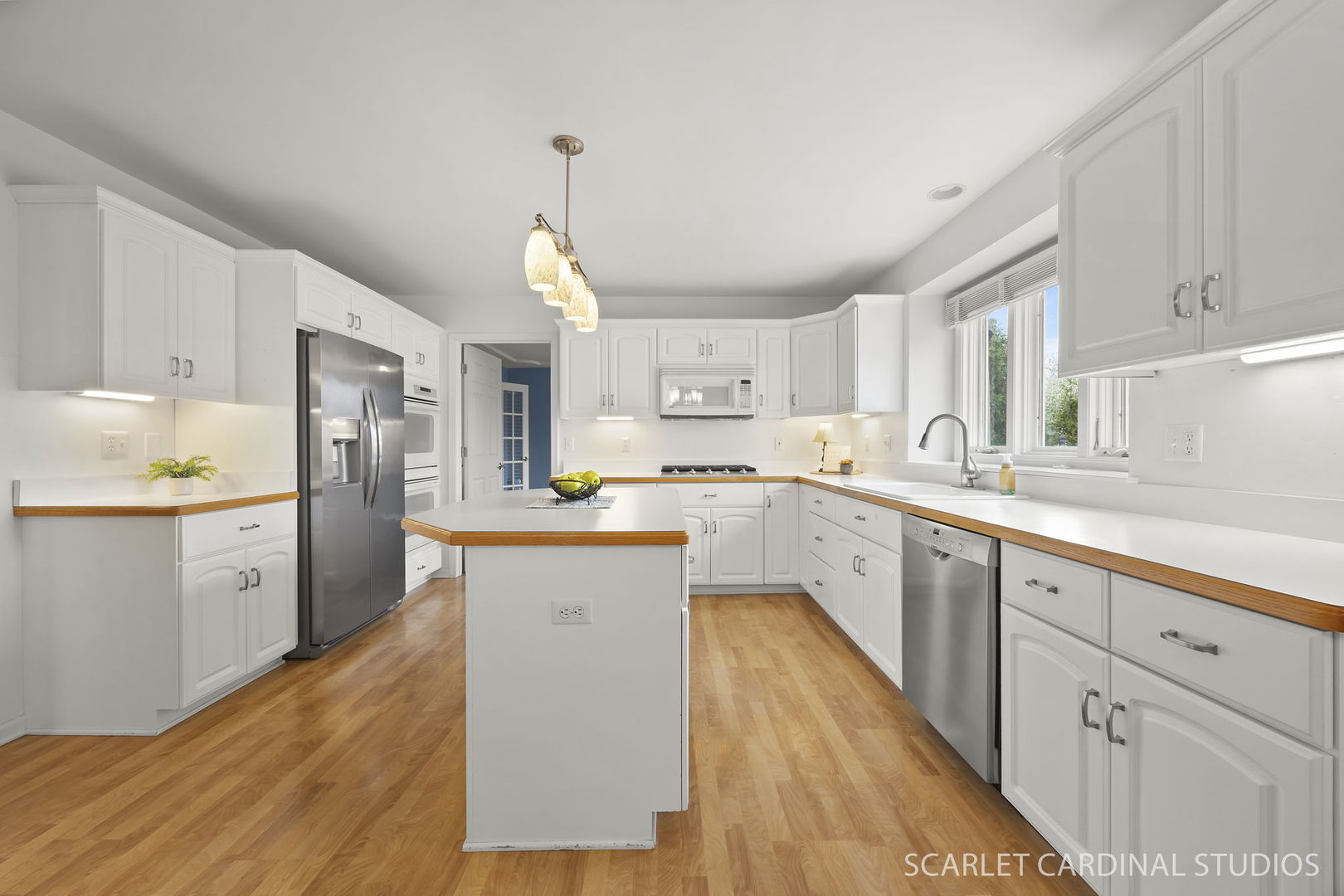 877 Elm Street Sugar Grove, IL 60554 - Photo 7 of 38 a kitchen with granite countertop white cabinets and white appliances