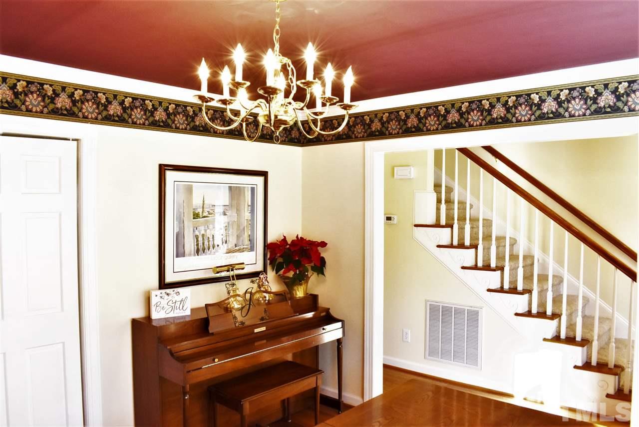 4629 Mill Rock Lane Raleigh, NC 27616 - Photo 3 of 30 a view of a dining room with furniture wooden floor and chandelier