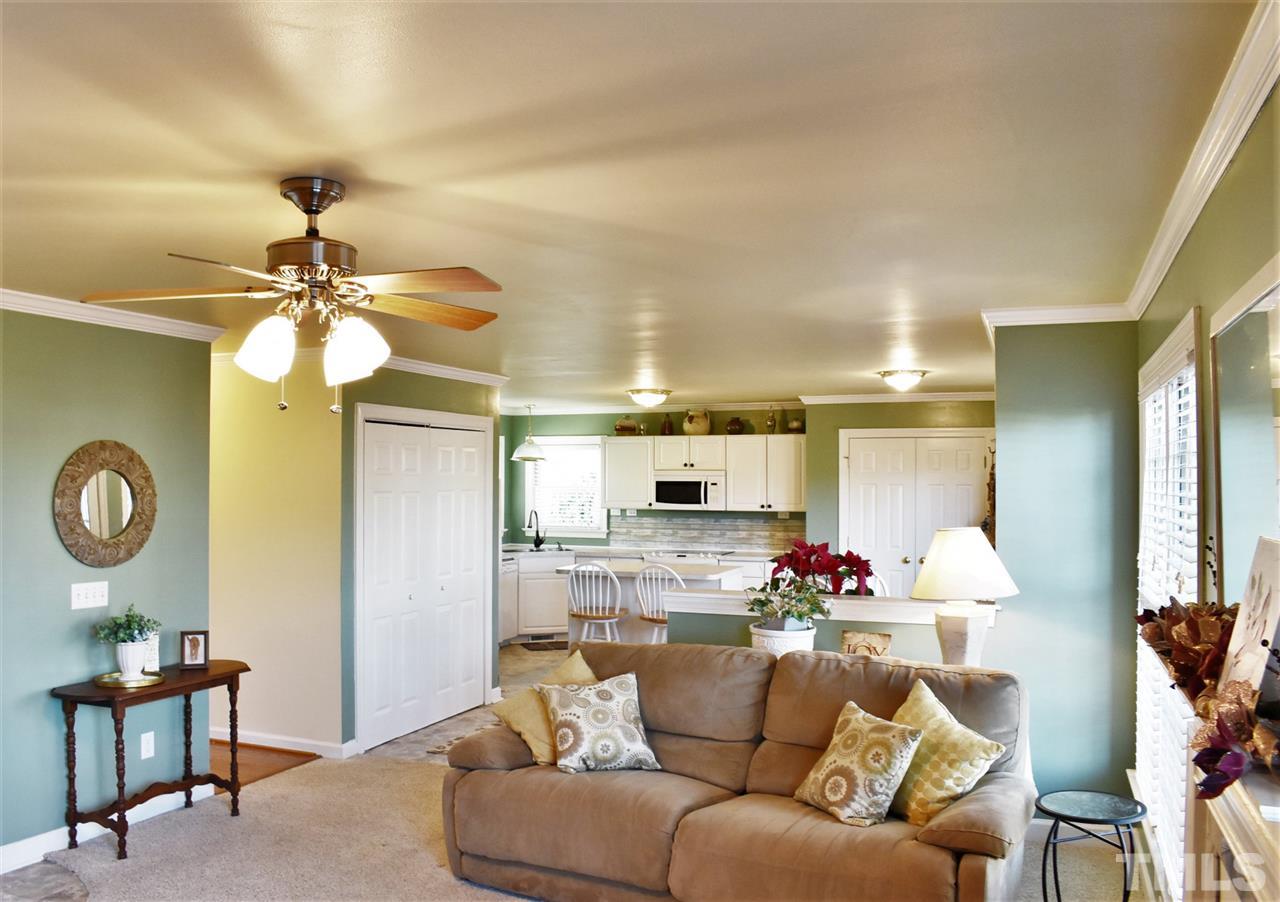 4629 Mill Rock Lane Raleigh, NC 27616 - Photo 7 of 30 a living room with furniture and a chandelier