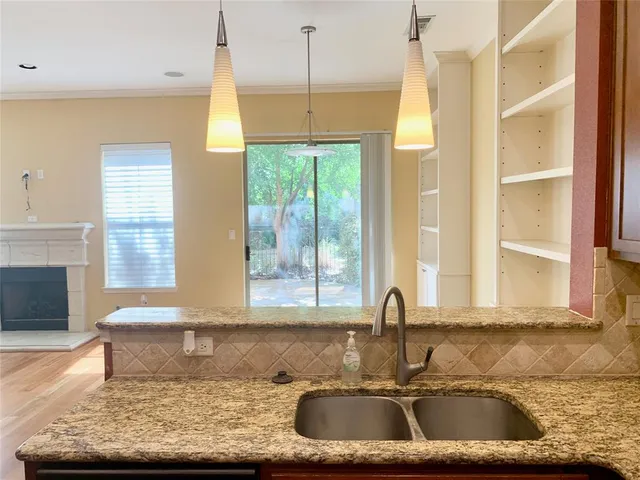 a kitchen with sink window and cabinets
