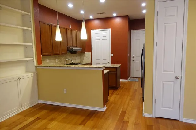 a view of a living room with a wooden floor
