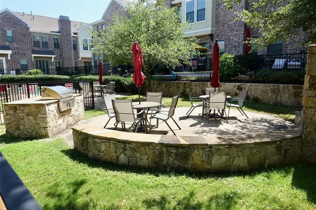 a view of a house with yard and sitting area