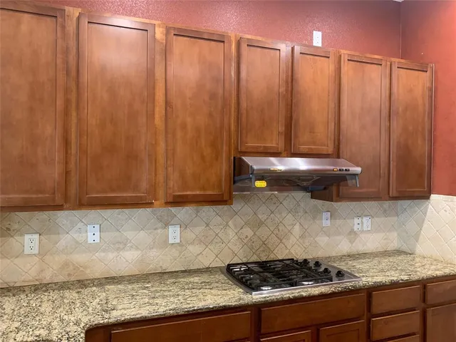 a kitchen with a stove and cabinets
