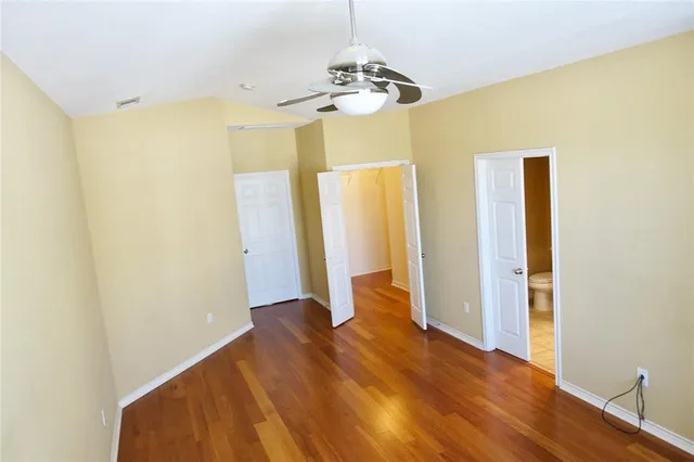 a view of a room with wooden floor