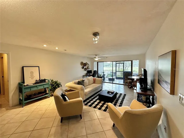 a living room with furniture or couch and a large window