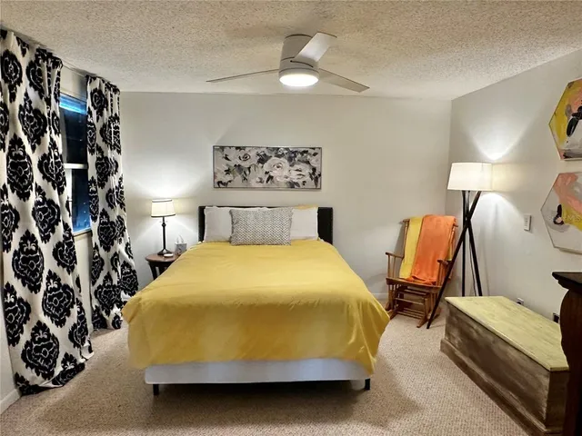 a bedroom with a bed and lamp with the dresser