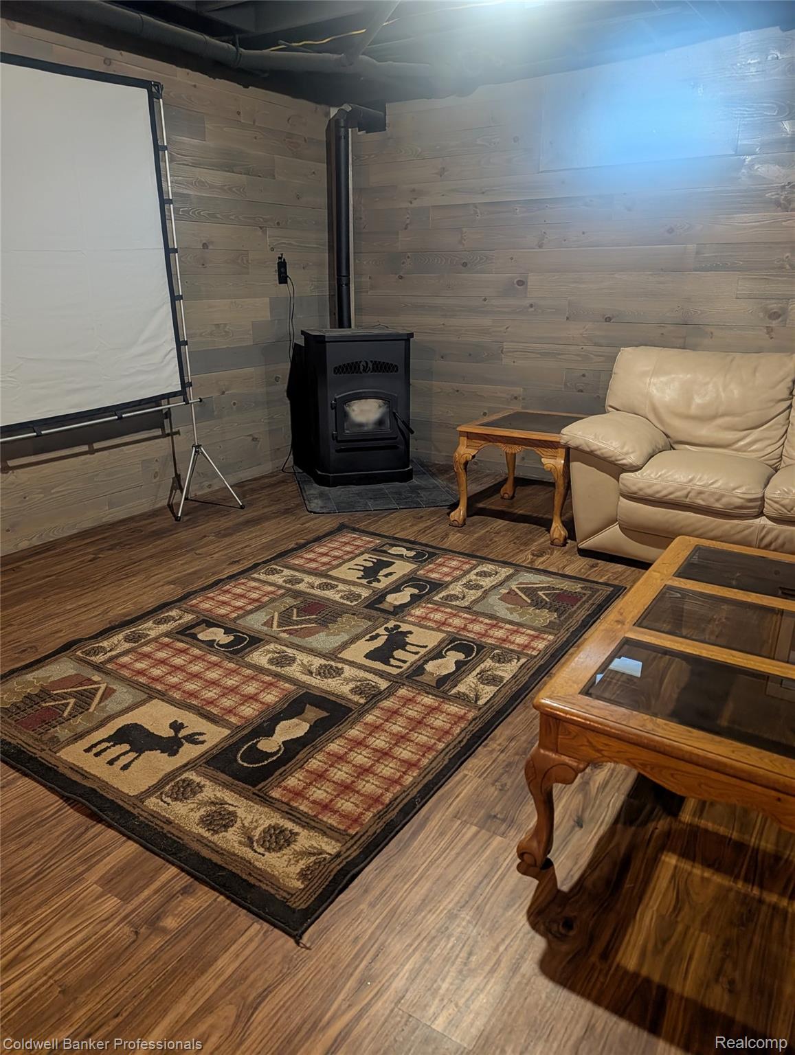 3210 South Kingston Road Kingston, MI 48741 - Photo 56 of 64 Living room with a wood stove, dark wood-style floors, and wooden walls