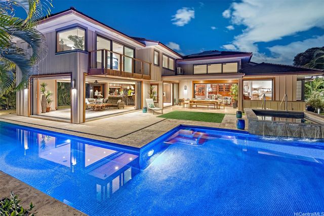 a swimming pool view with a outdoor seating space