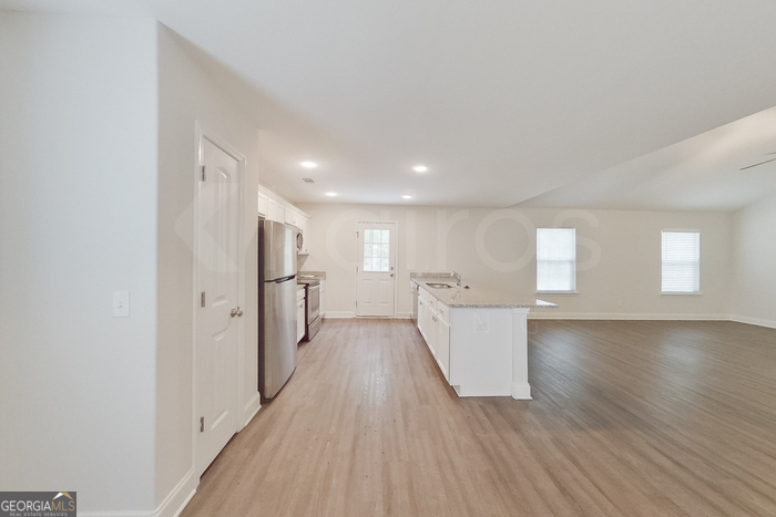 231 Western Red Cedar Drive Springfield, GA 31329 - Photo 6 of 26 a view of a kitchen with wooden floor and electronic appliances