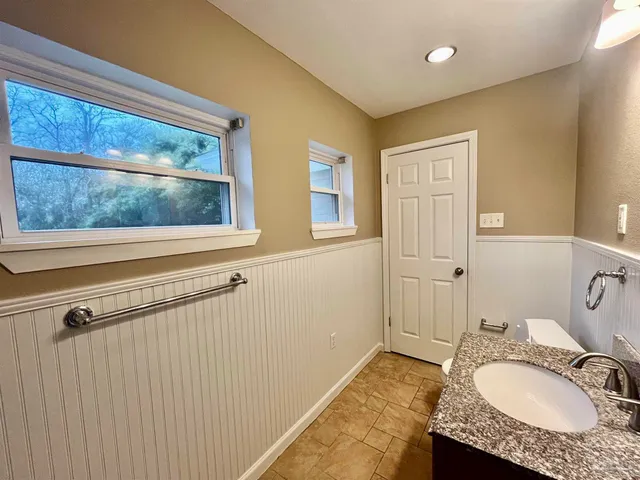 an empty room and chandelier fan