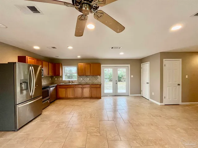 a kitchen with stainless steel appliances granite countertop a stove a sink and a microwave