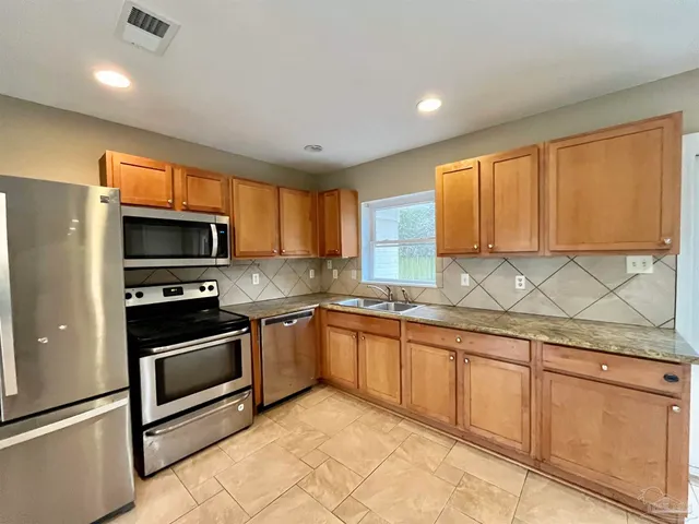 a view of a kitchen with a sink and a large window