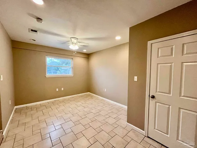a bathroom with a granite countertop toilet sink and a mirror