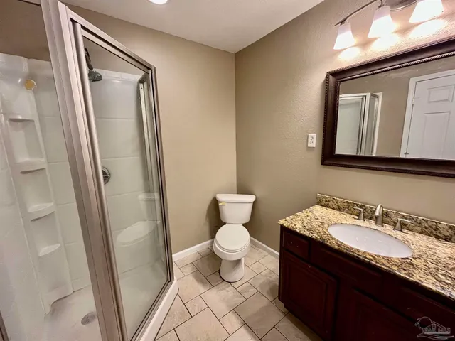 an empty room and chandelier fan