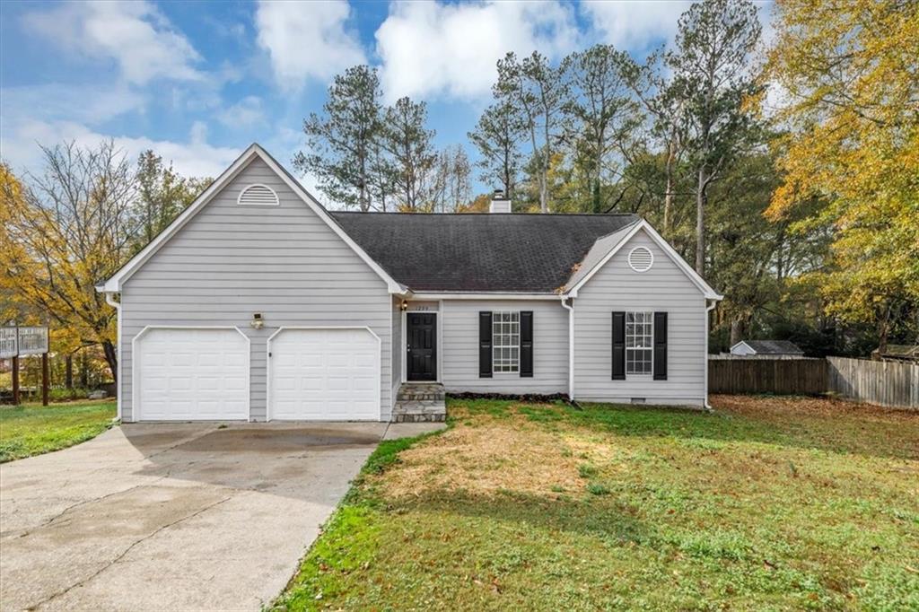 1299 Paddocks Way Powder Springs, GA 30127 - Photo 1 of 1 a view of a house with a yard and garage