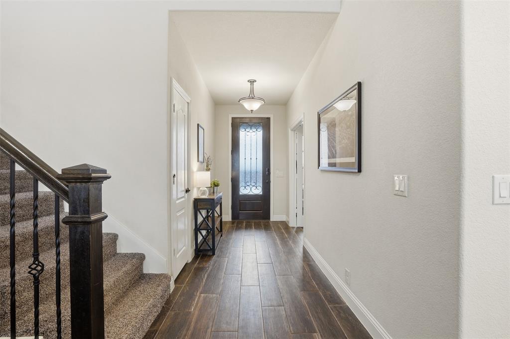 4002 Grove Valley Road Midlothian, TX 76065 - Photo 7 of 40 a view of a hallway with wooden floor and staircase
